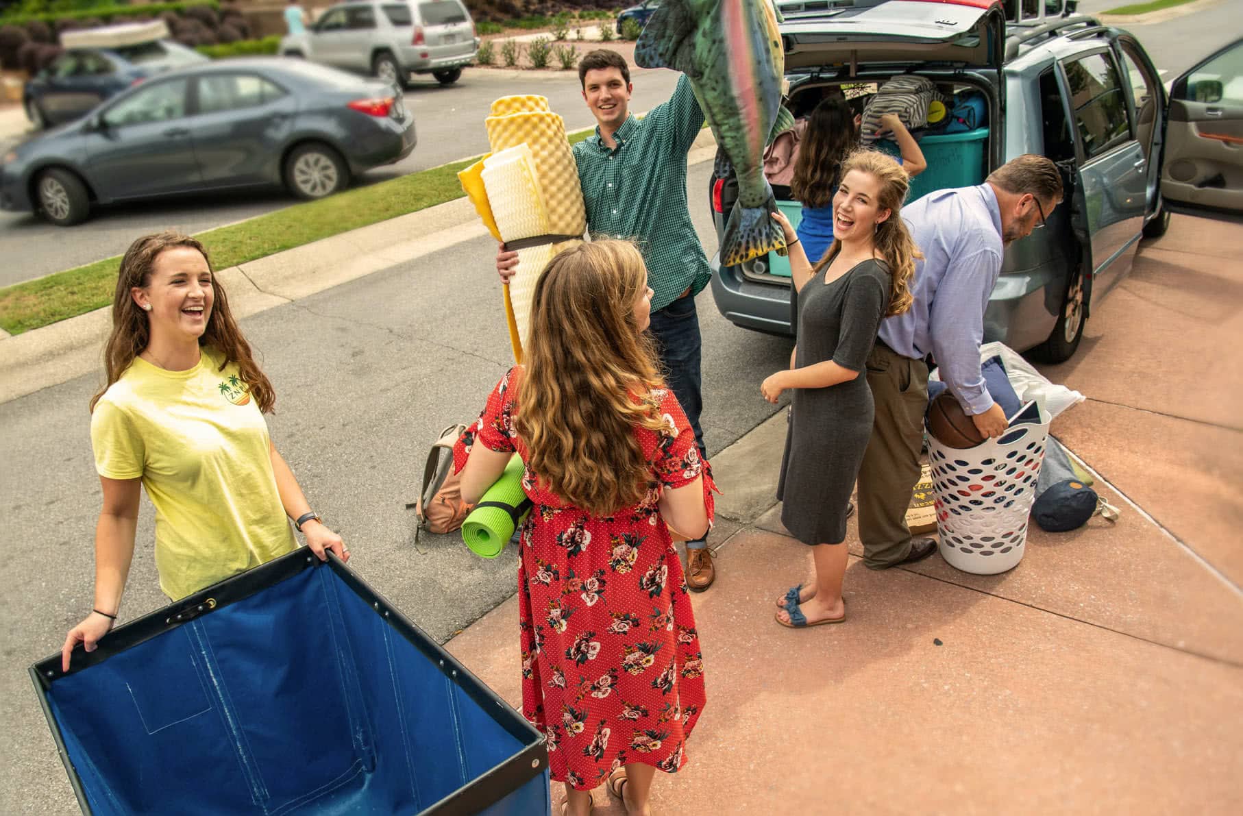 A family works together to get two college girls' stuff packed