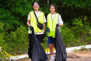 A PCC girl helps clean up at Carpenters Creek through the Serve Pensacola activity