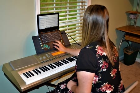 Audrey Betz practicing piano while finishing the spring semester at home.