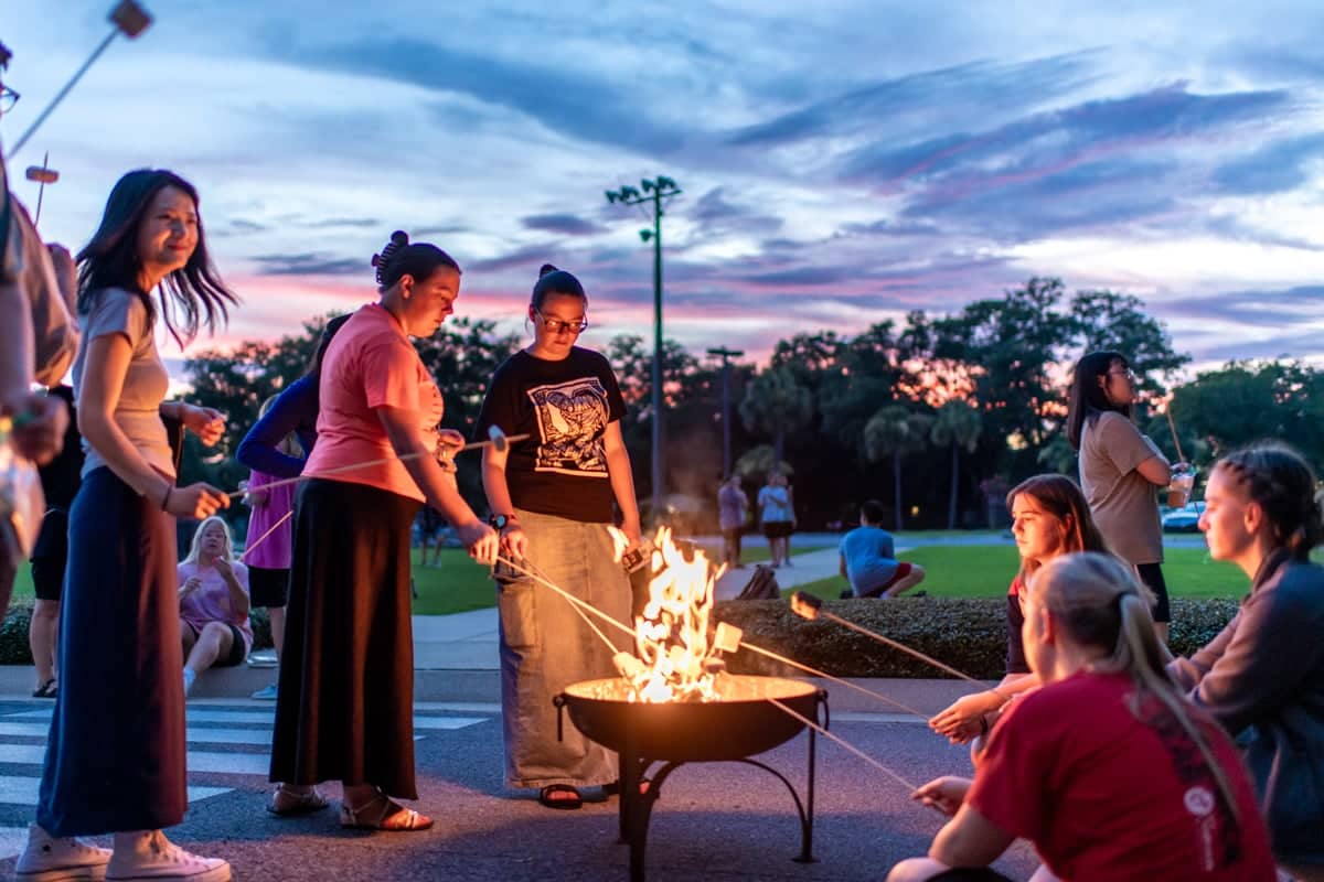 PCC summer workers enjoy an evening making s'mores with friends