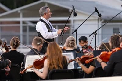 PCCymphony Conductor leads music at Concert on the Green