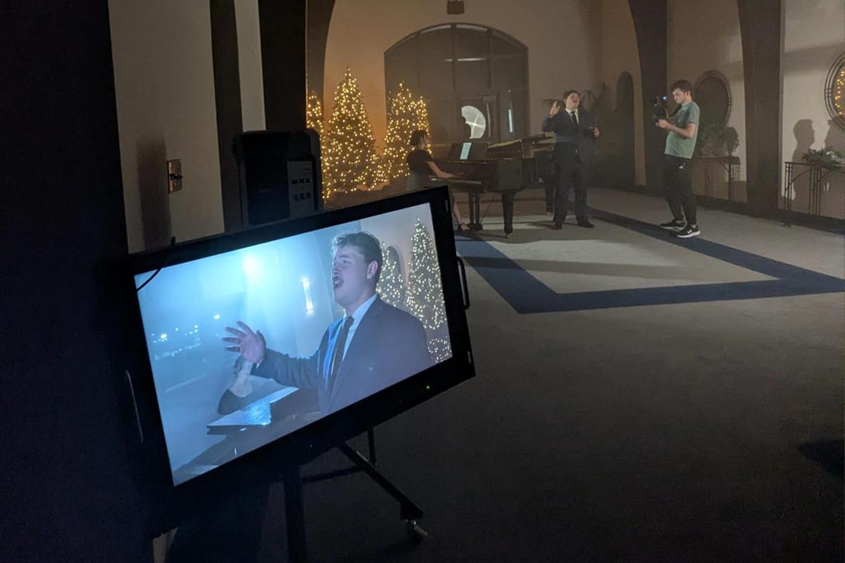 Singer and cameraman filming