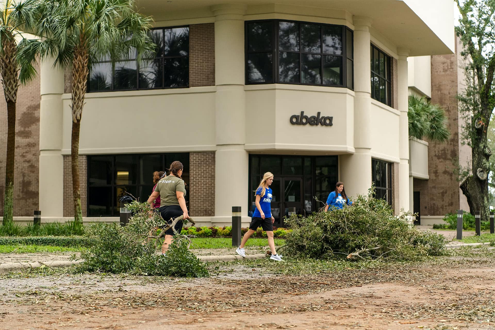 Students clean up outside the Abeka building