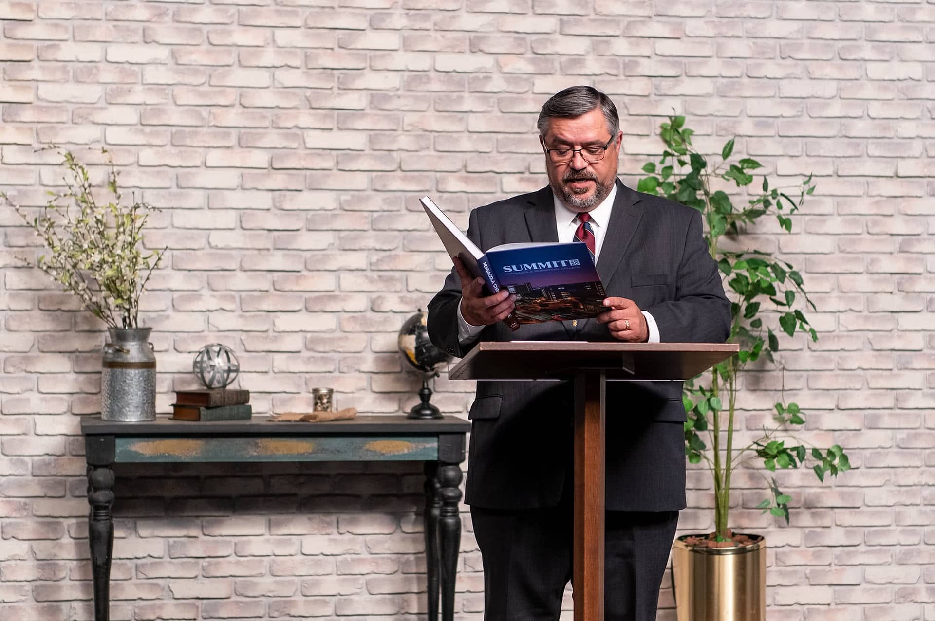 Dr. Shoemaker holding a copy of the PCC Summit Yearbook