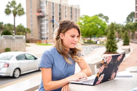 Student working on online learning classes while on campus.