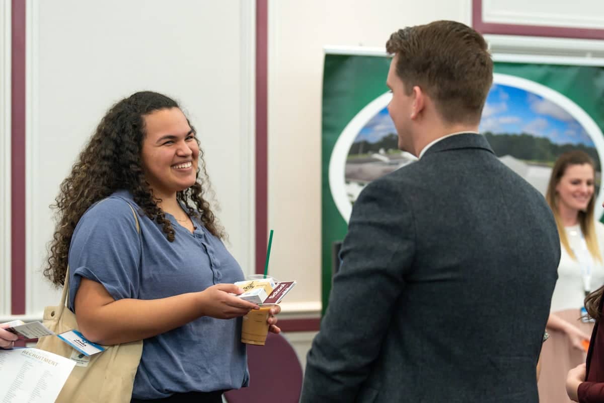 Girl talks to a recruiter at PCC's Educator Recruitment event