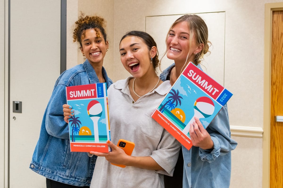 Students pose with the new 2023 Summit Yearbook