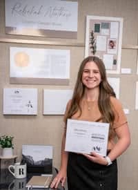 Rebekah Northrop poses in front of art display