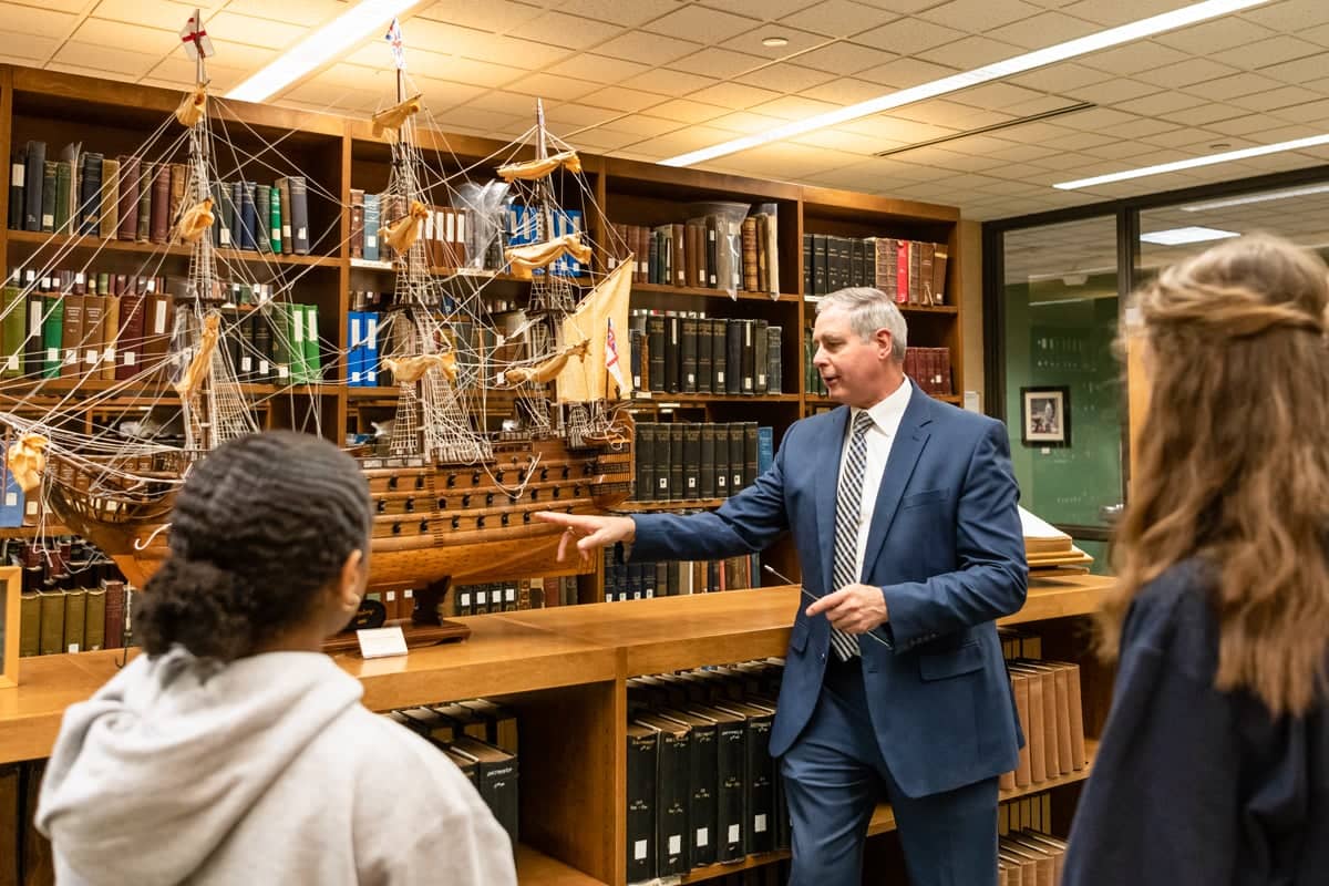 PCC teacher Dr. Reese speaks to students in the Rare book Room