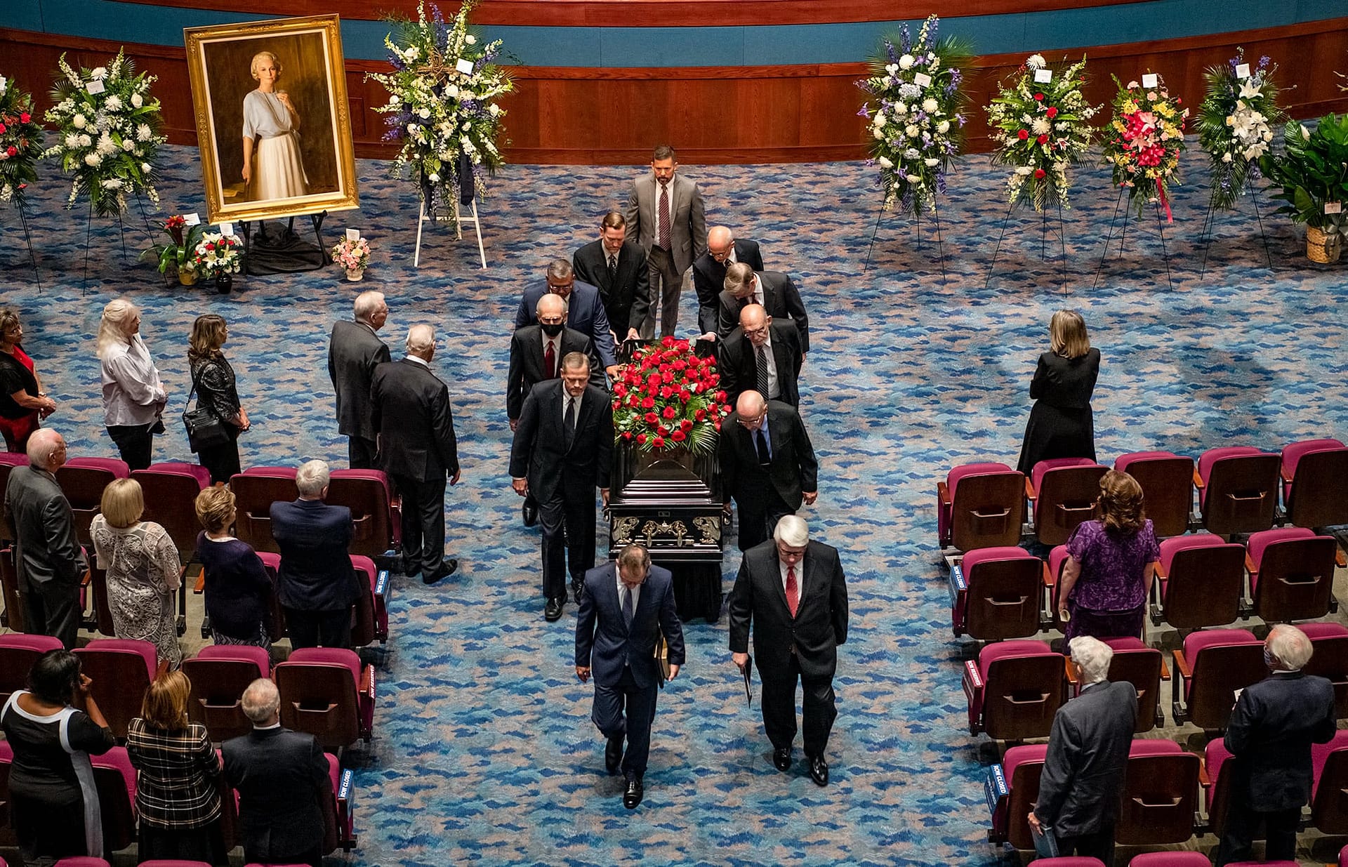 Pallbearers carrying the casket up the aisle.