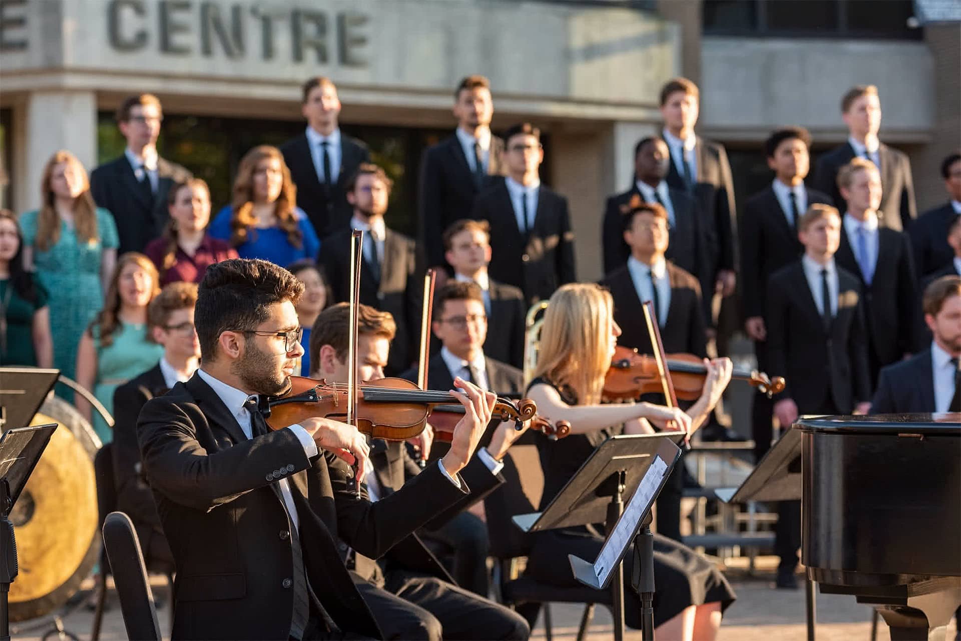 Choir and orchestra in front of Crowne Centre